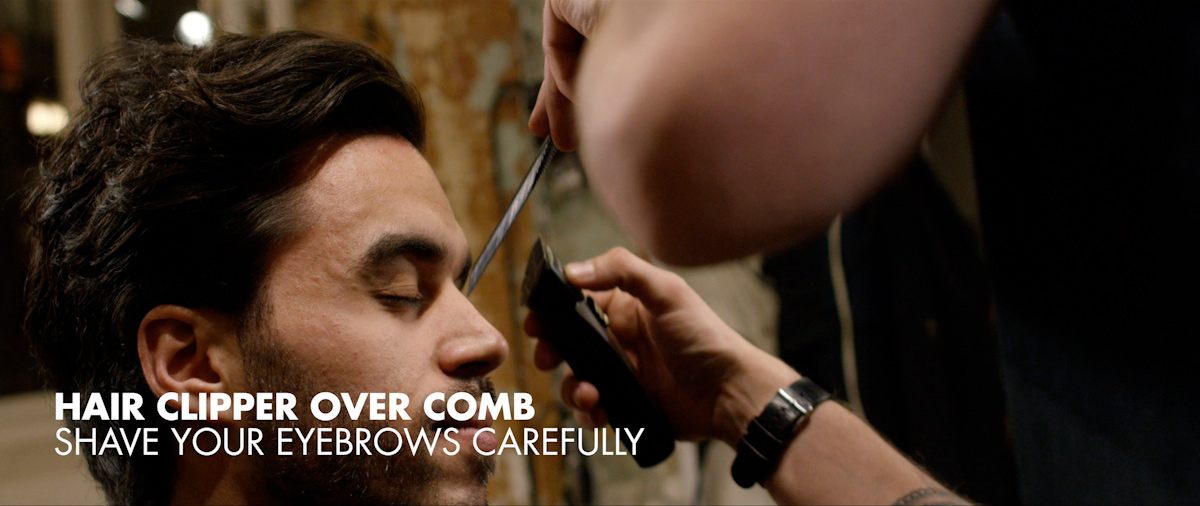 Styling the eyebrows carefully with a hair clipper over comb