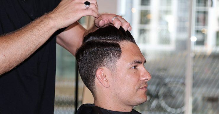 Man getting his hair styled by the hairdresser